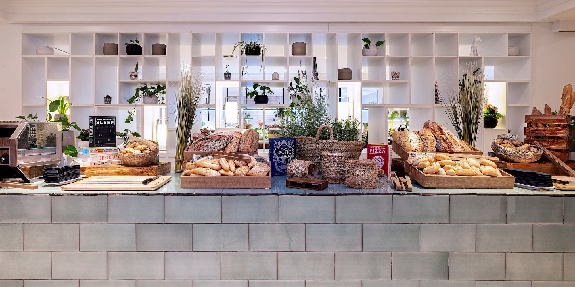Fresh bread and rolls on a modern breakfast buffet display.