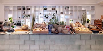 a counter with baskets of bread and plants
