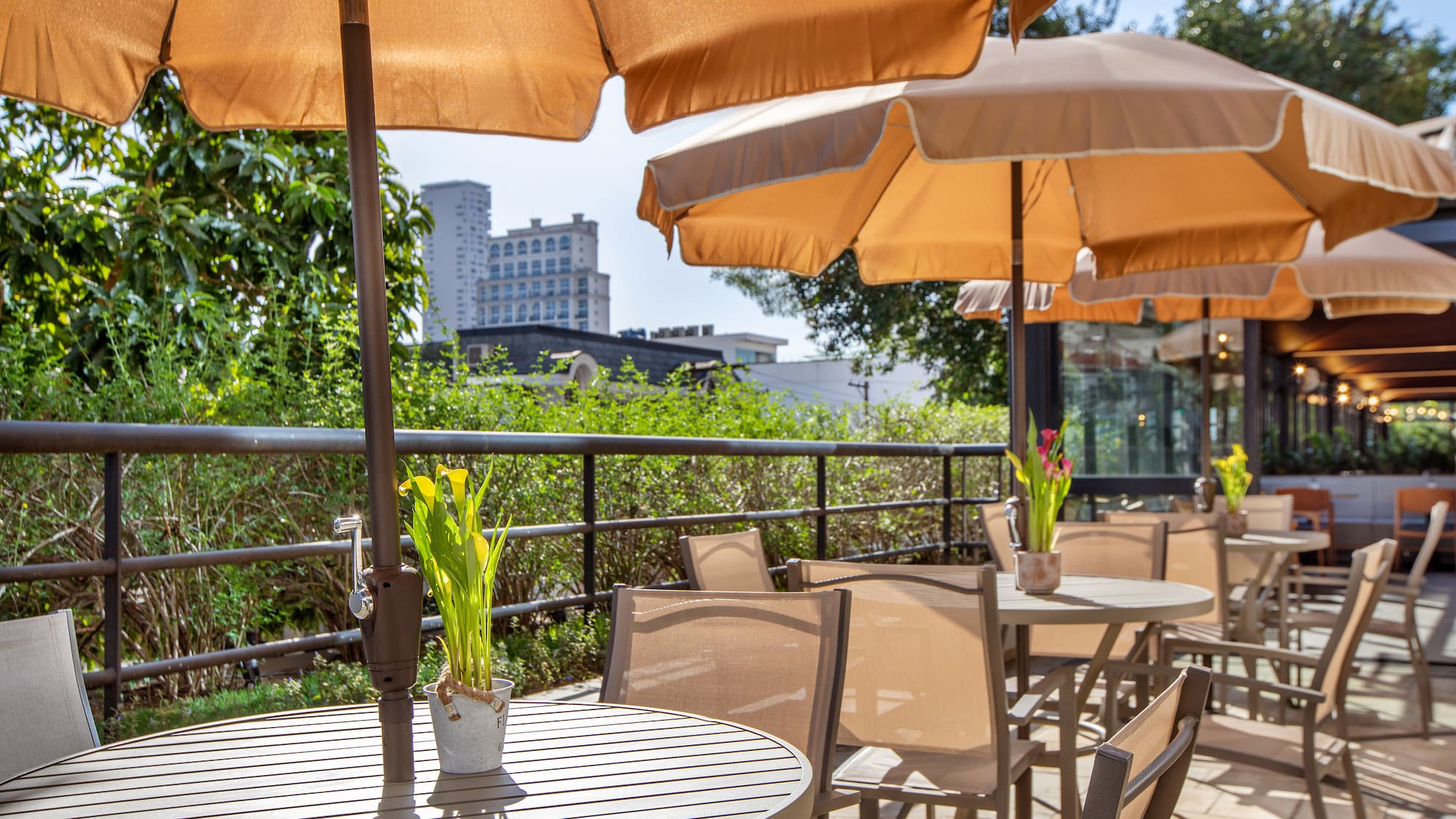 a table and chairs with umbrellas on a patio