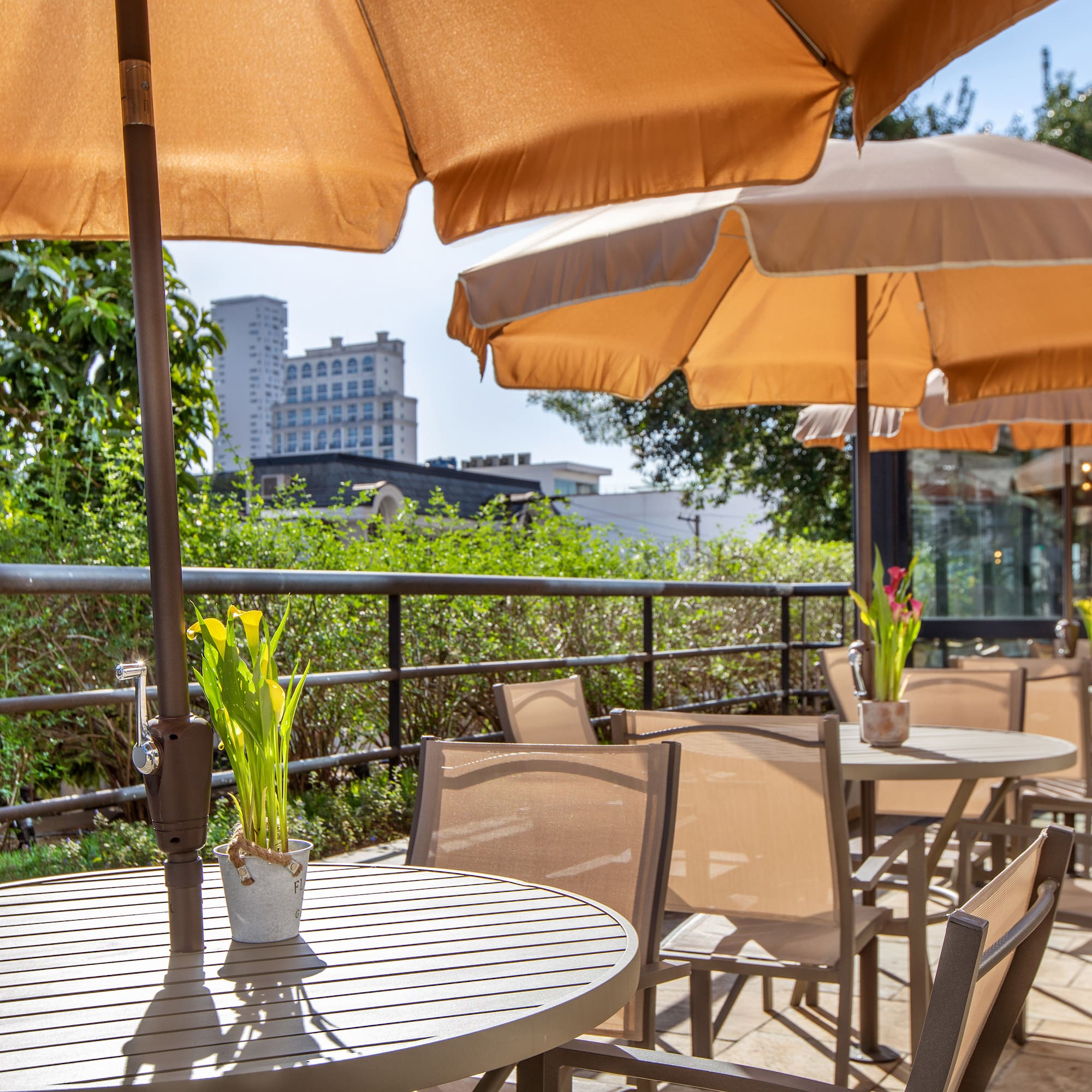 a table and chairs with umbrellas on a patio