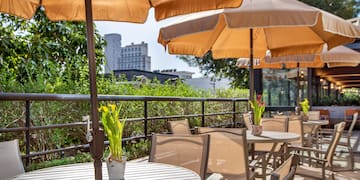 a table and chairs with umbrellas on a patio
