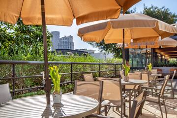 a table and chairs with umbrellas on a patio