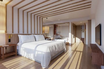 a bedroom with a bed and a wood floor