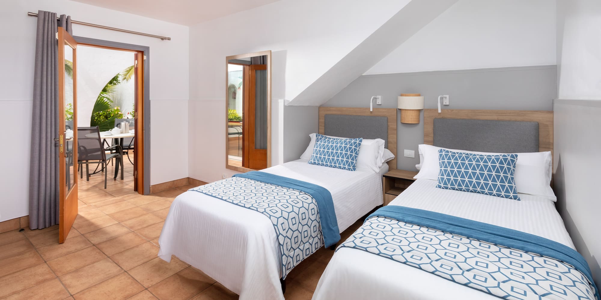 a room with two beds and a table