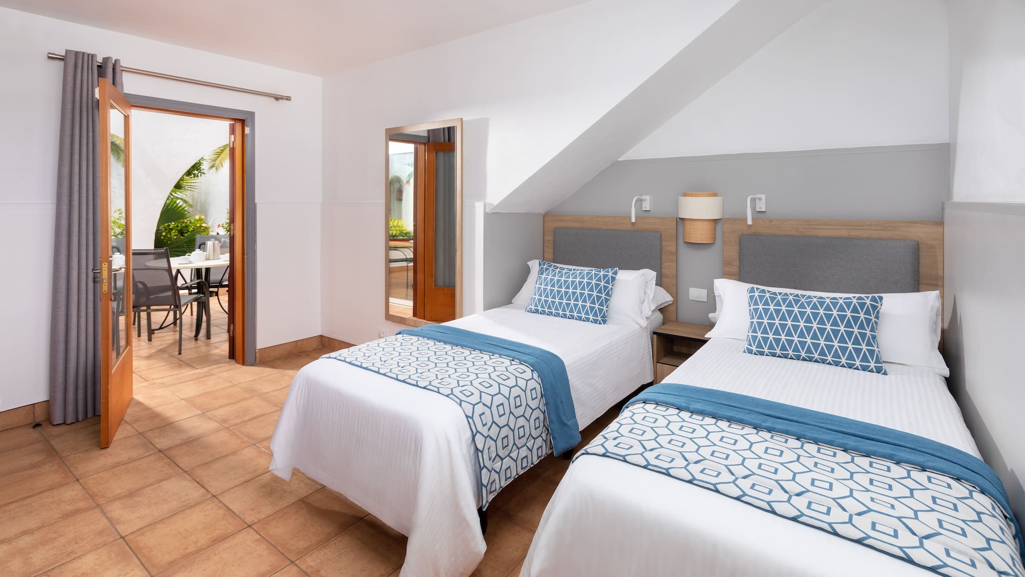 a room with two beds and a table