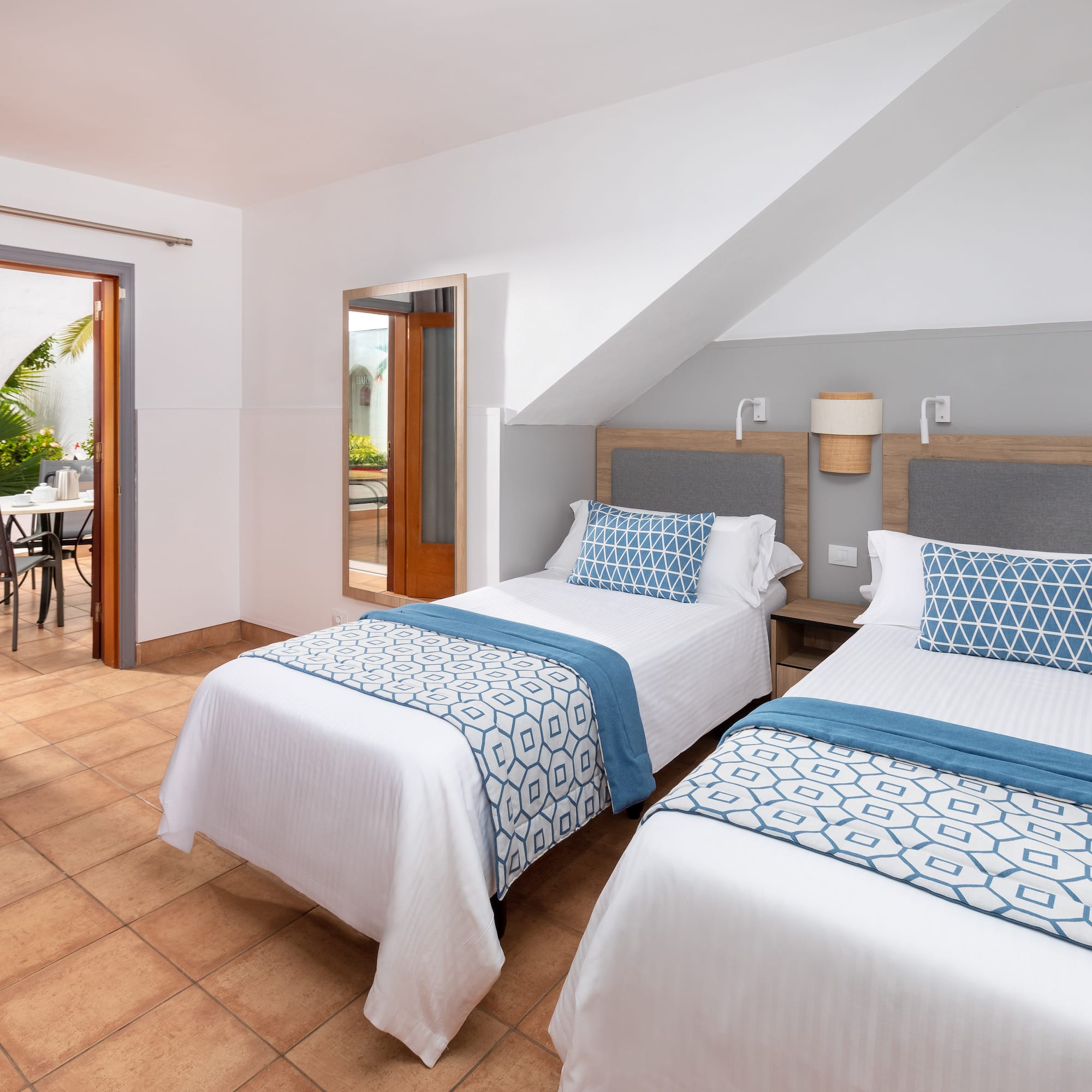 a room with two beds and a table