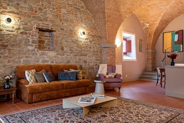 a living room with brick walls and a couch and a coffee table