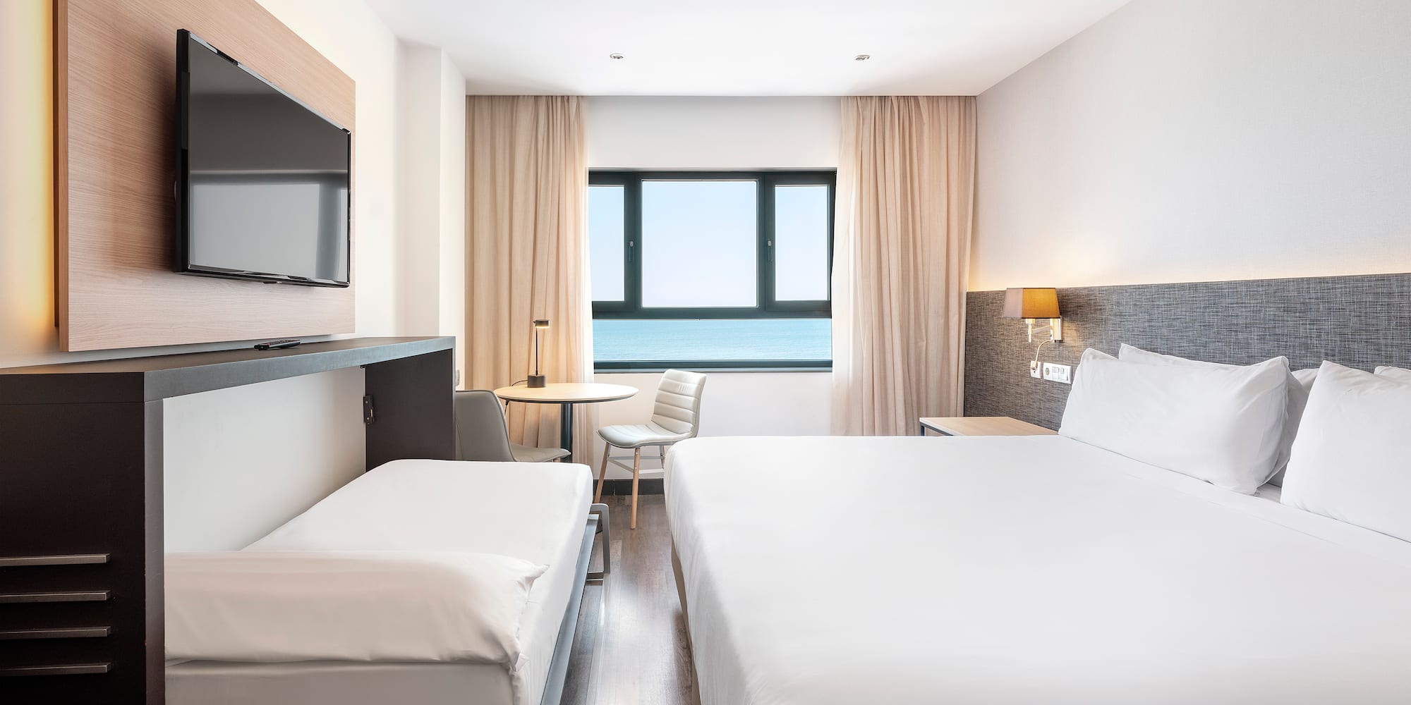 a room with a bed and a television