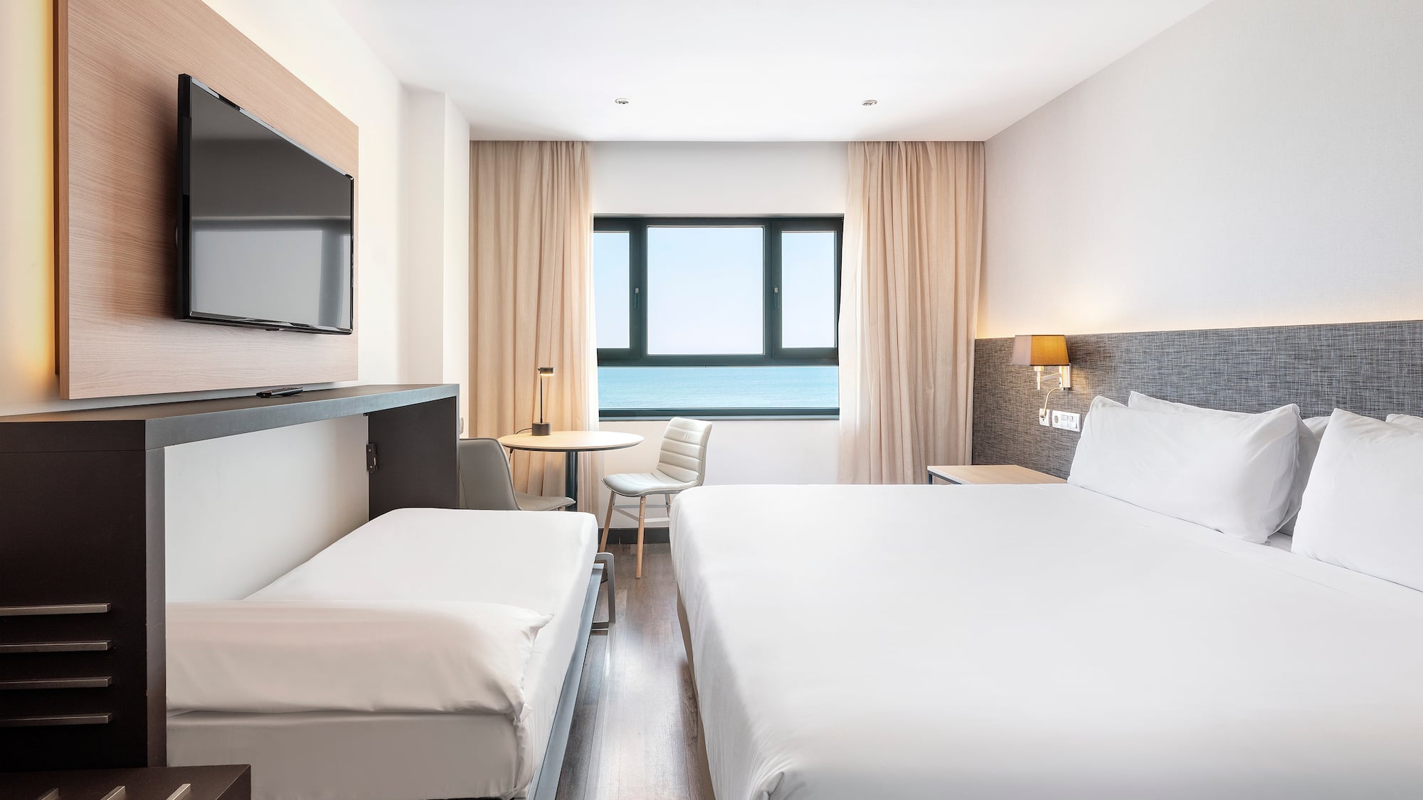 a room with a bed and a television