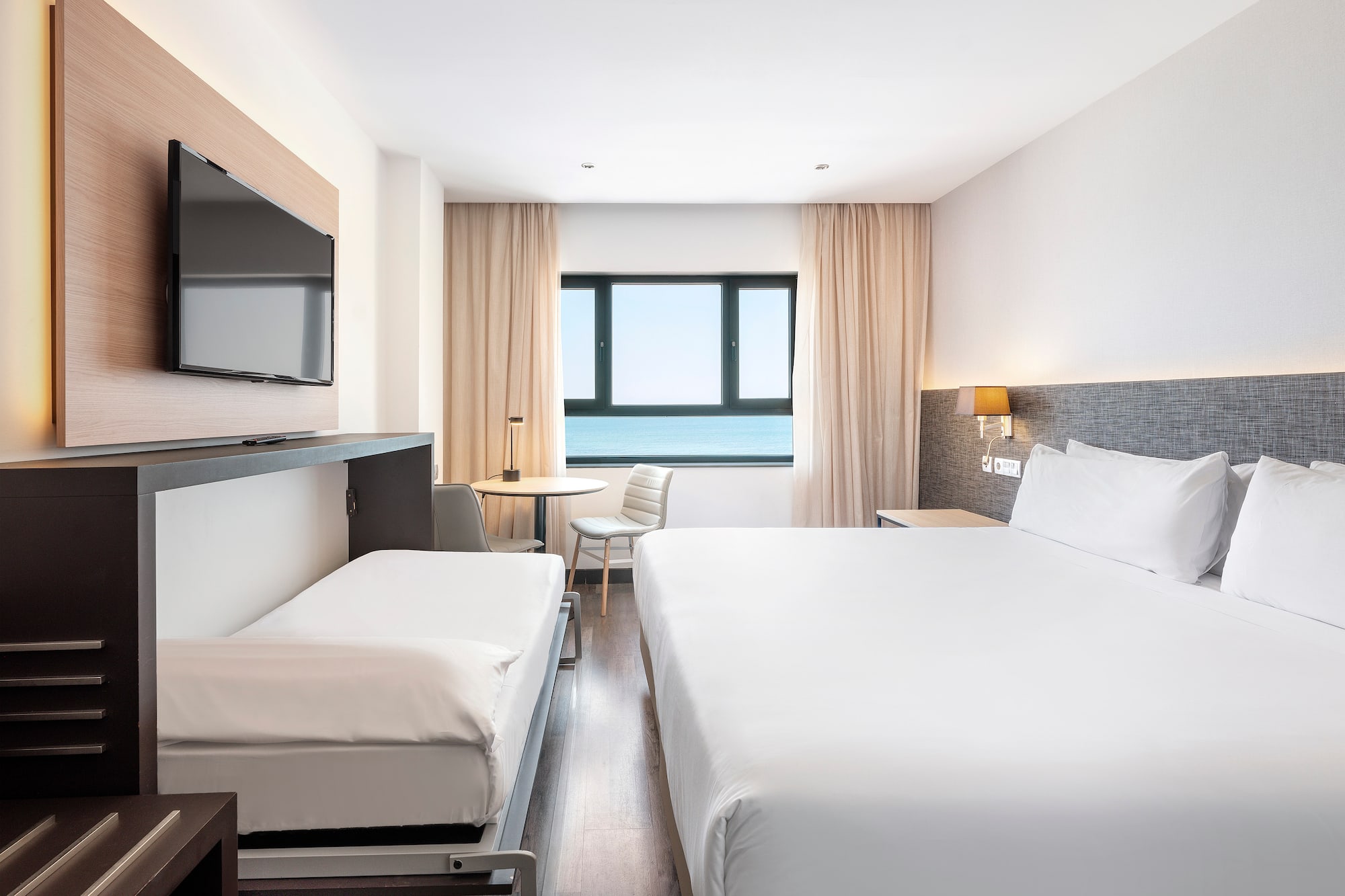 a room with a bed and a television