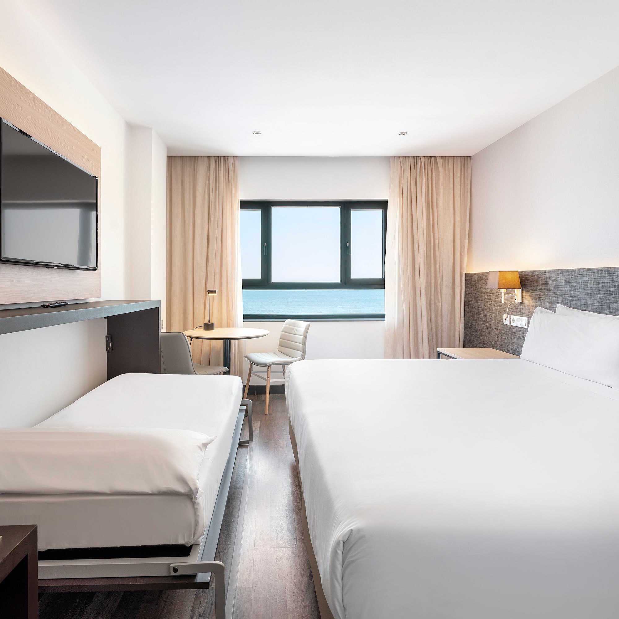 a room with a bed and a television