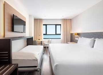 a room with a bed and a television