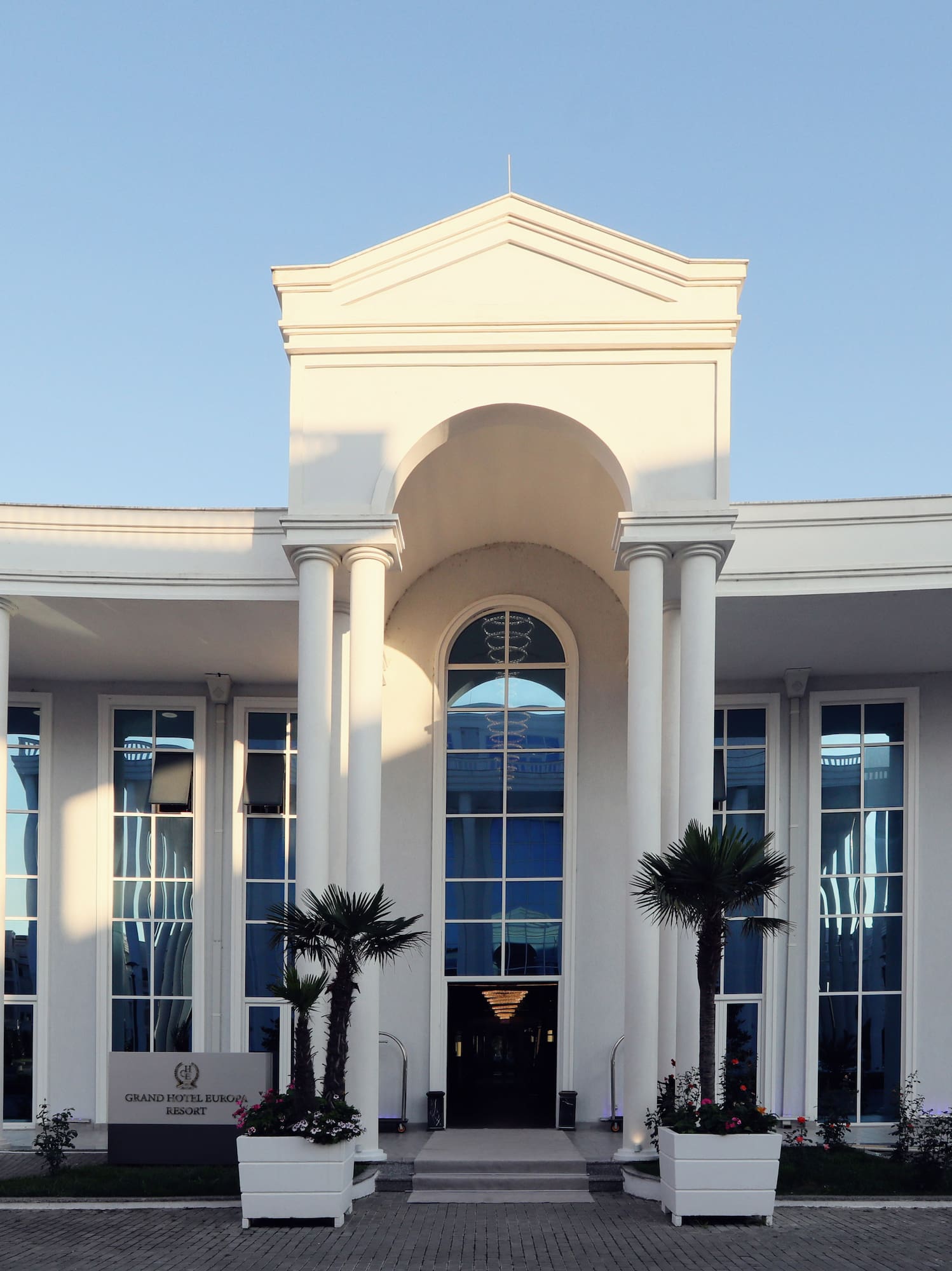 a white building with columns and a door