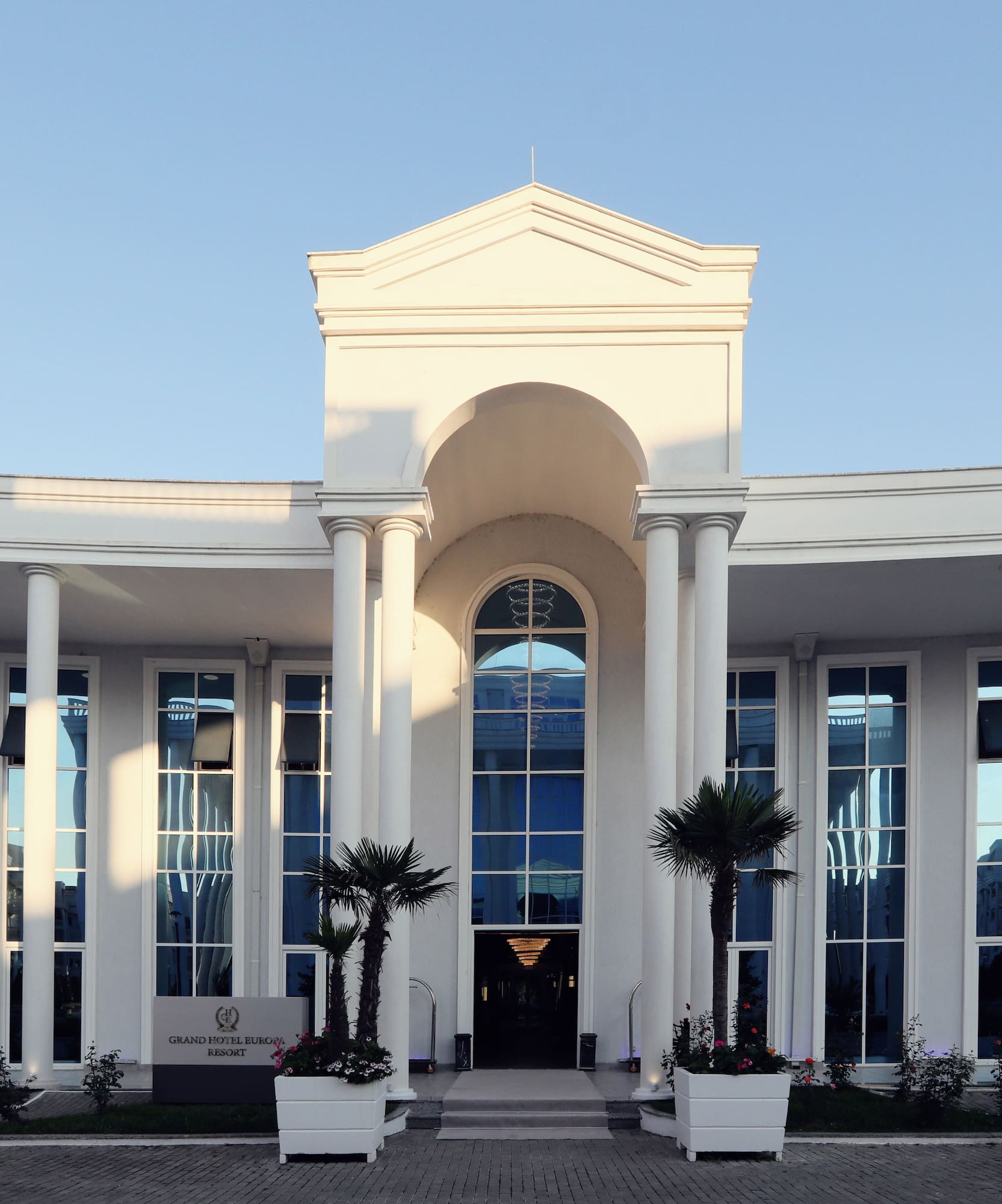 a white building with columns and a door