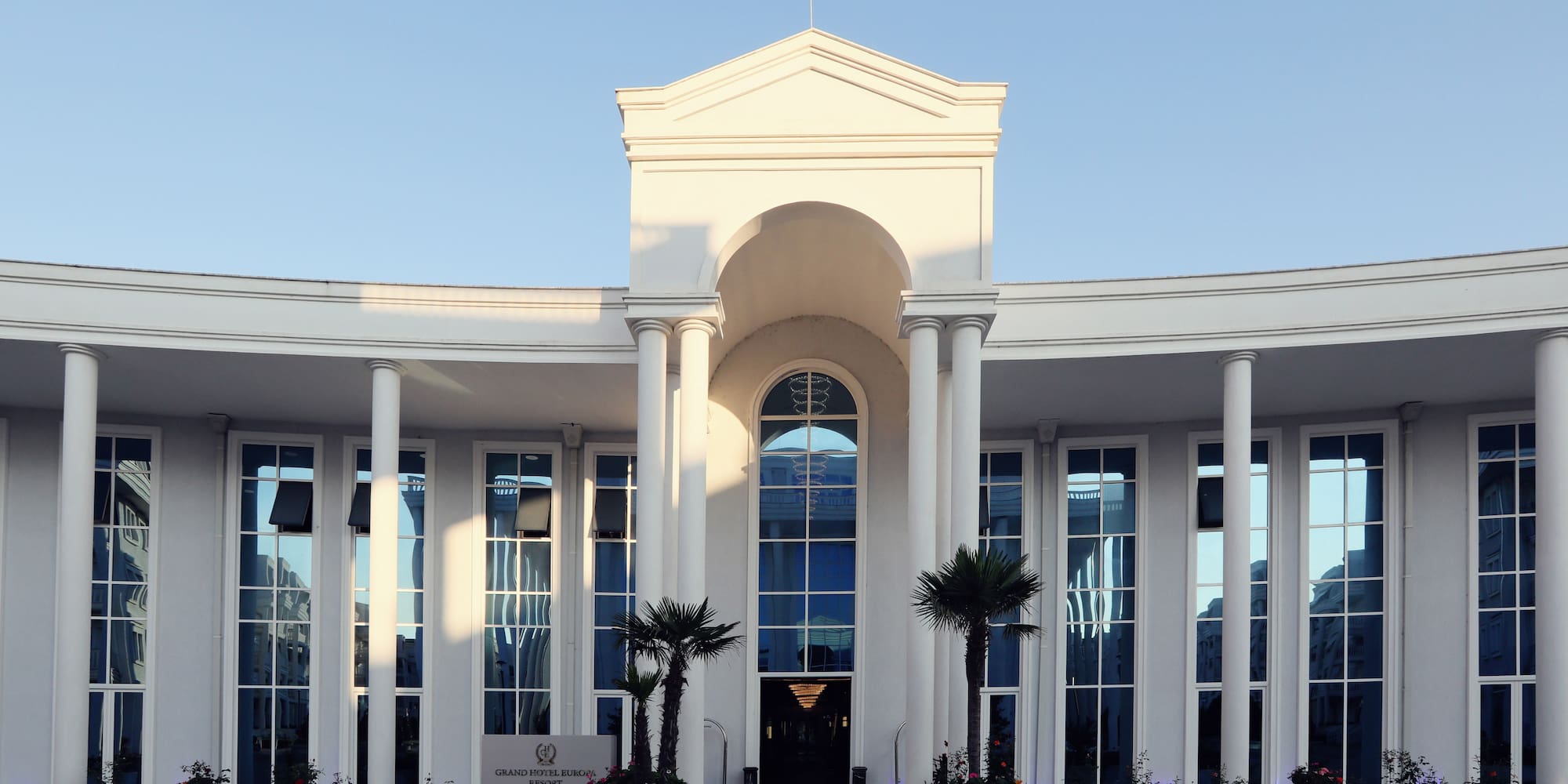 a white building with columns and a large doorway