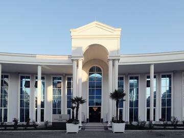 a white building with columns and a large doorway