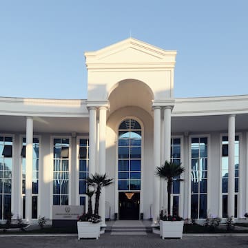 a white building with columns and a door