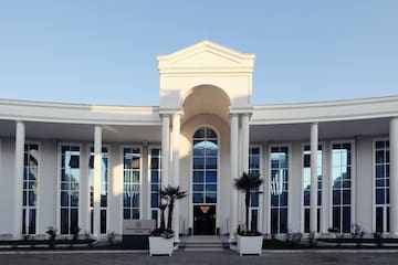 a white building with columns and a door