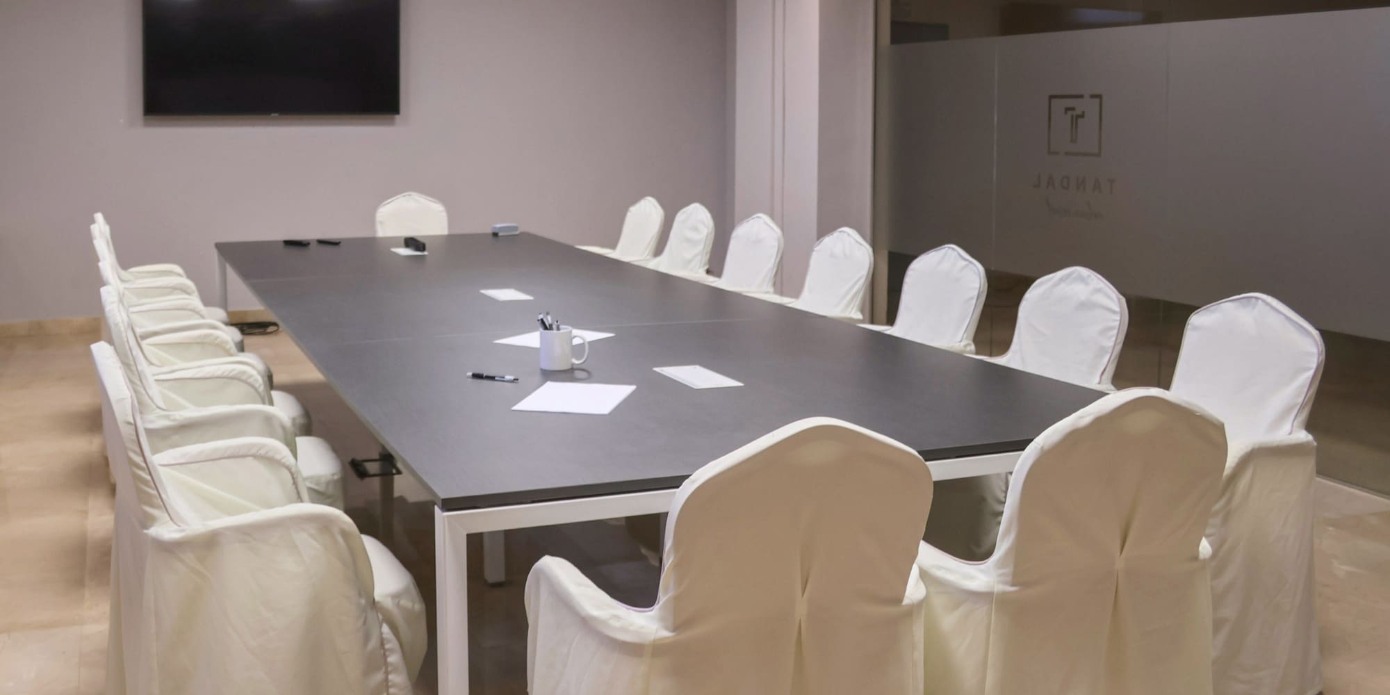 a conference room with a table and chairs