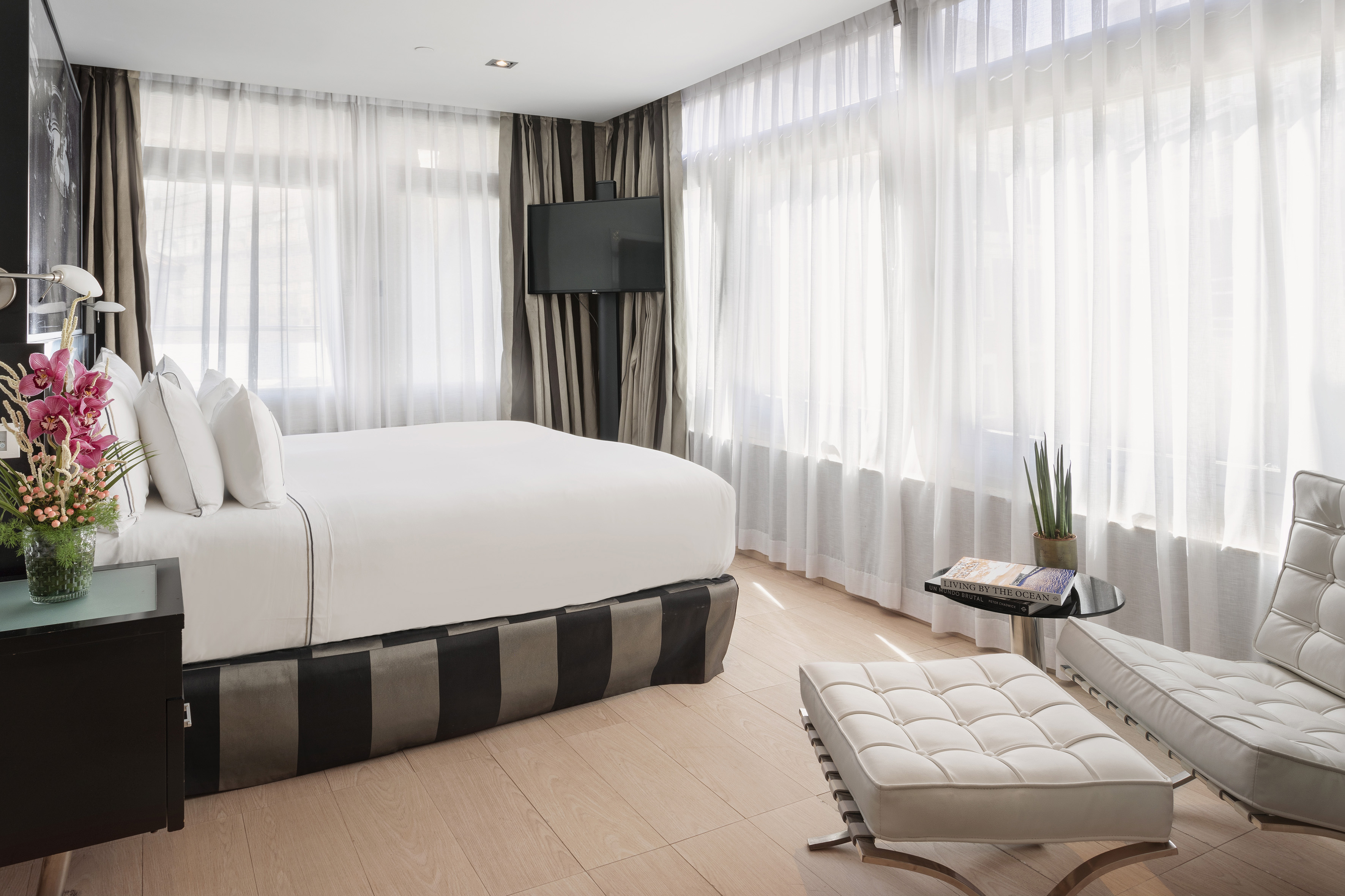 a bedroom with a bed and a foot stool