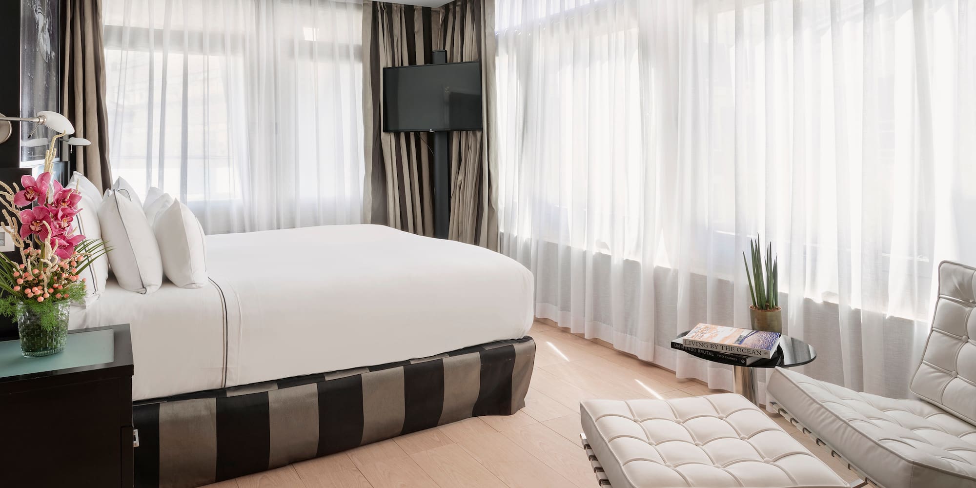 a bedroom with a bed and a foot stool