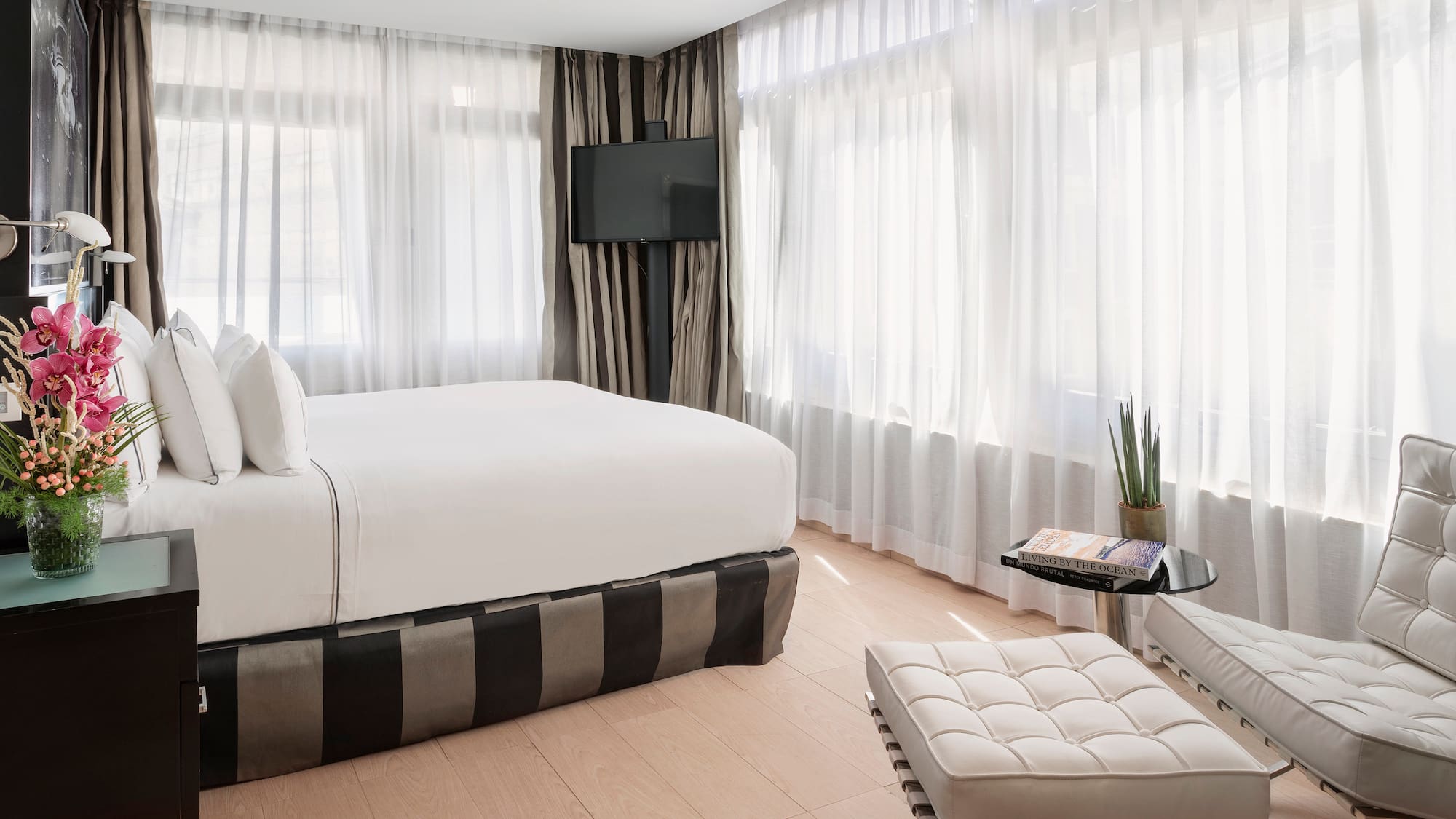 a bedroom with a bed and a foot stool