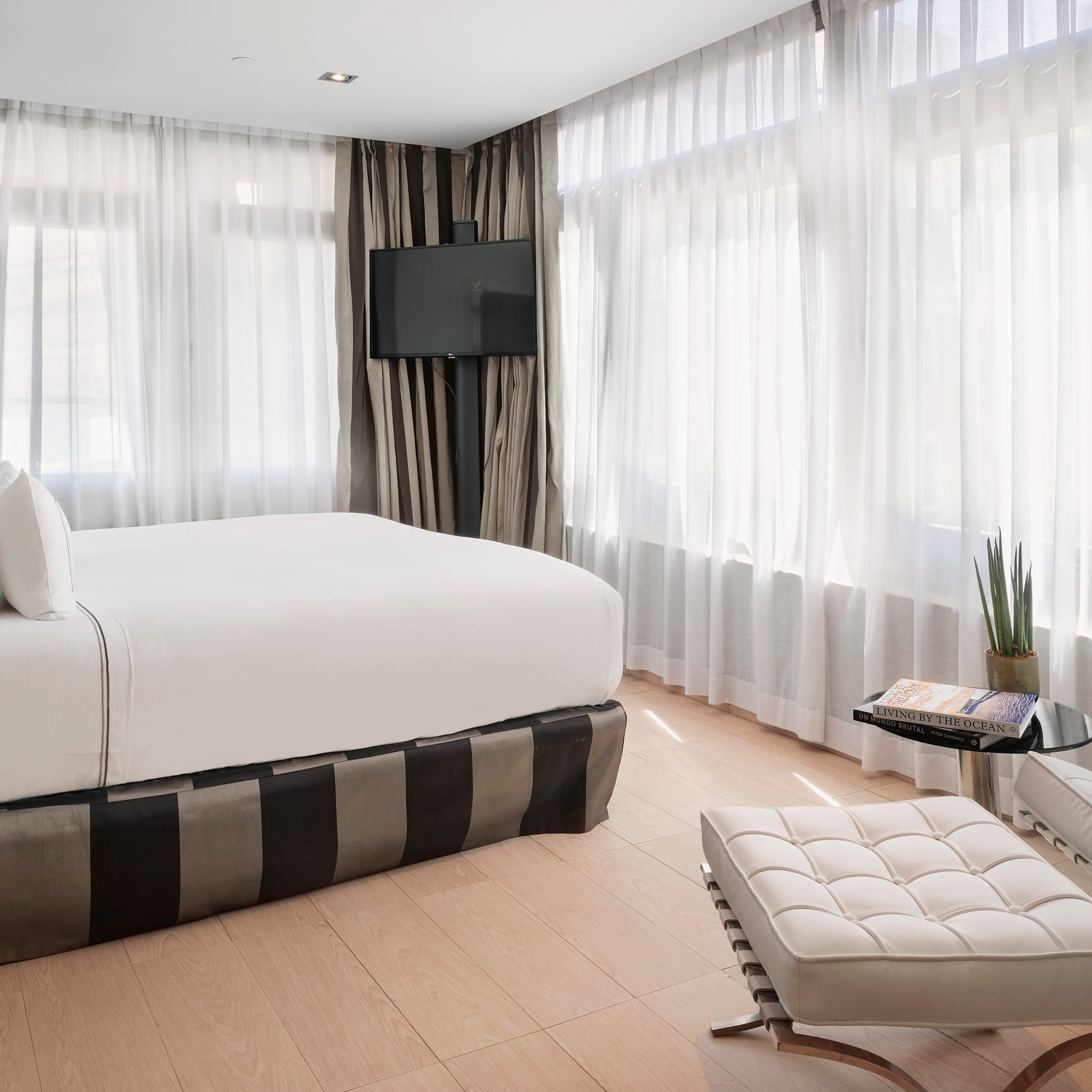 a bedroom with a bed and a foot stool