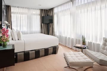 a bedroom with a bed and a foot stool