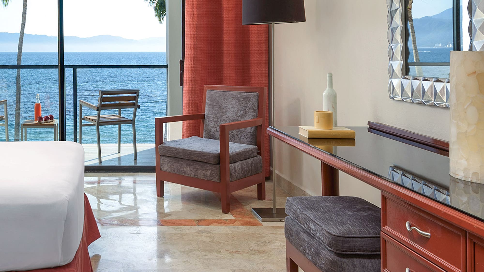 a room with a bed and a table and chairs