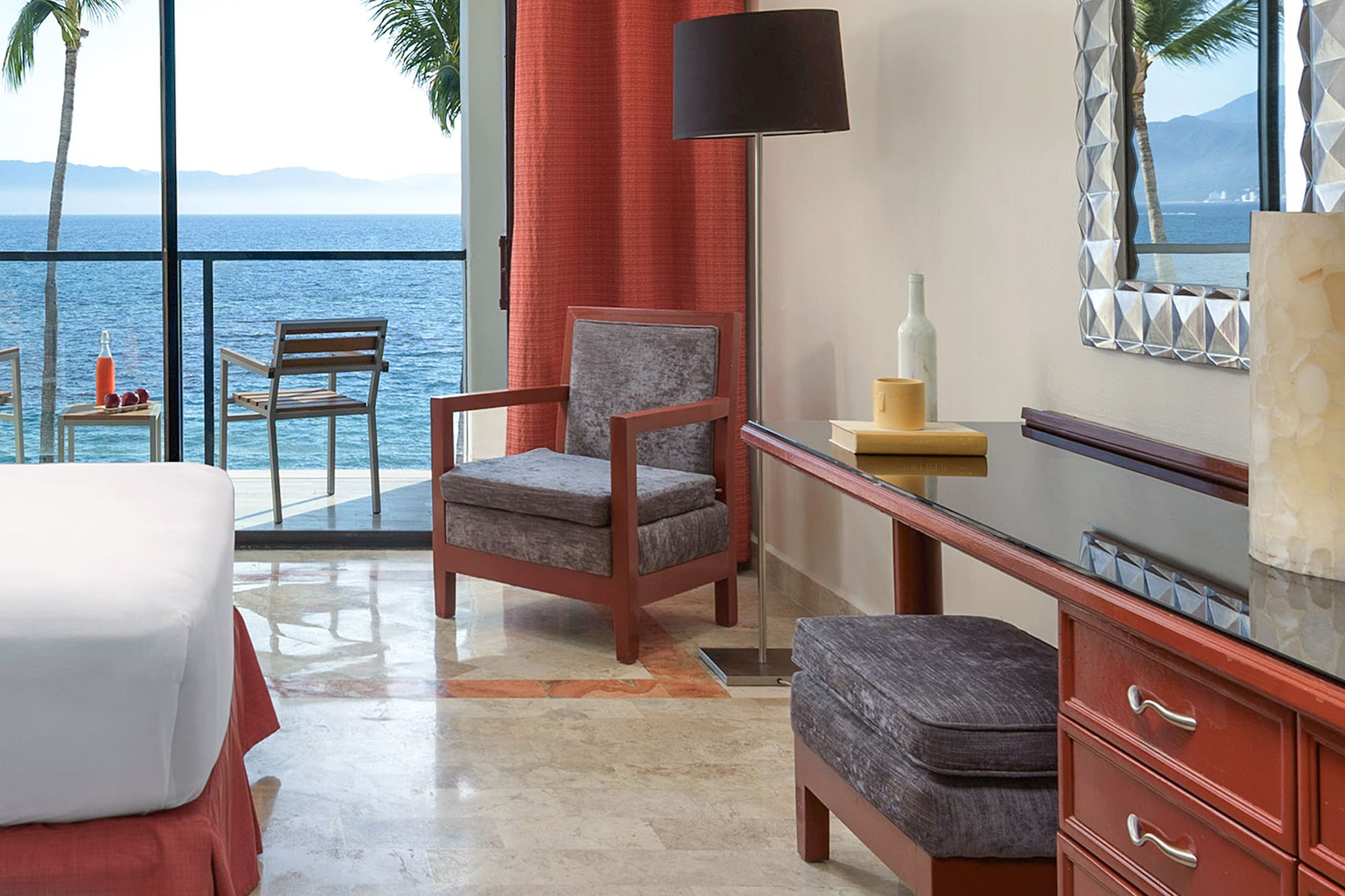 a room with a bed and a table and chairs