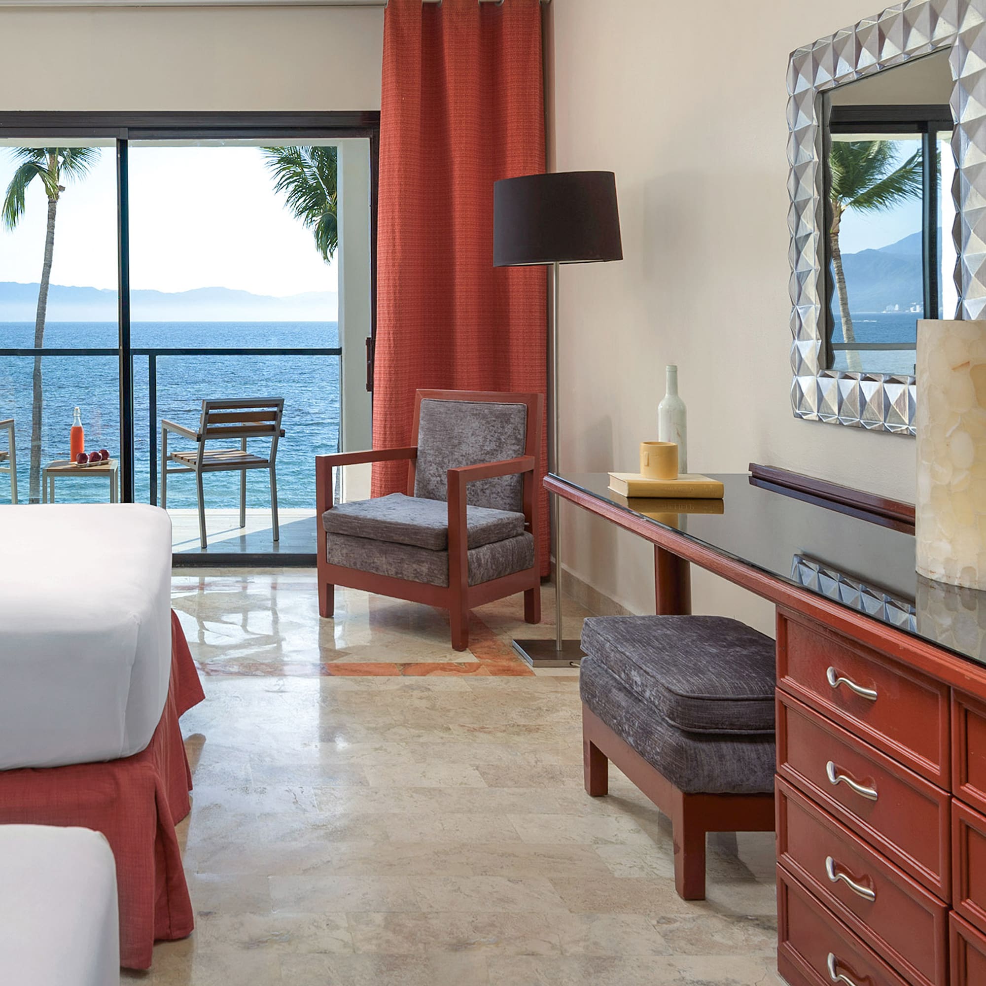 a room with a bed and a table and chairs