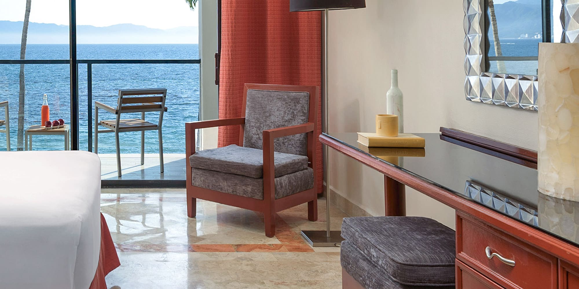 a room with a bed and a table and chairs