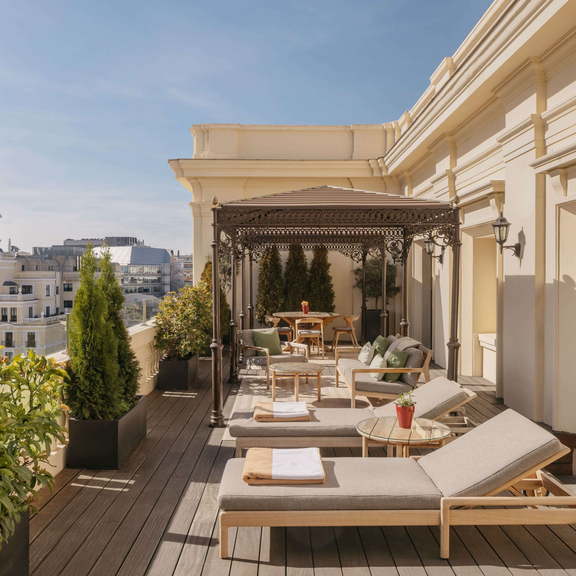 a patio with chairs and tables on a deck