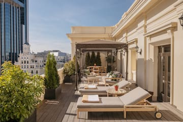 a patio with chairs and tables on a deck
