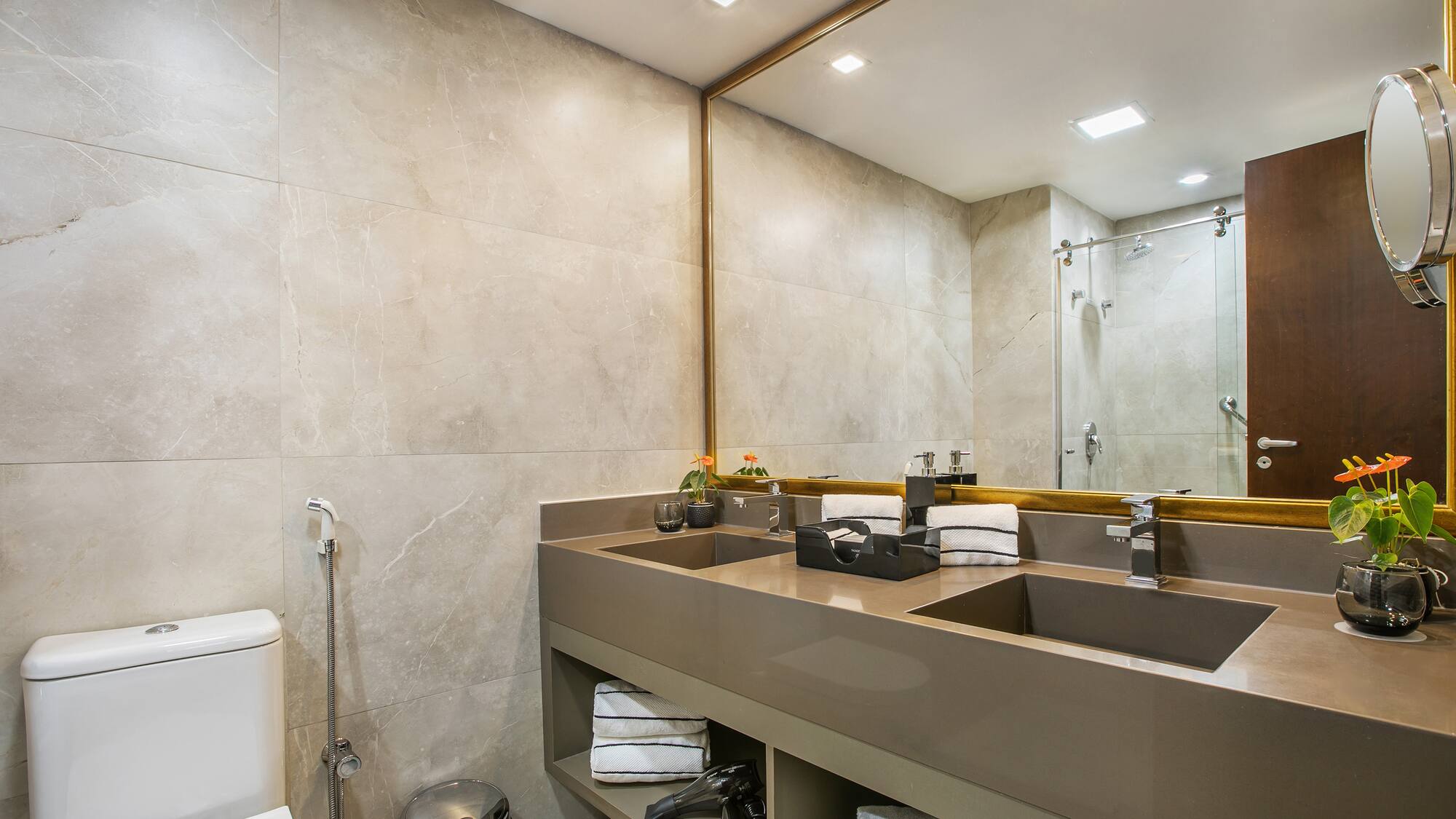 a bathroom with a large mirror and sinks