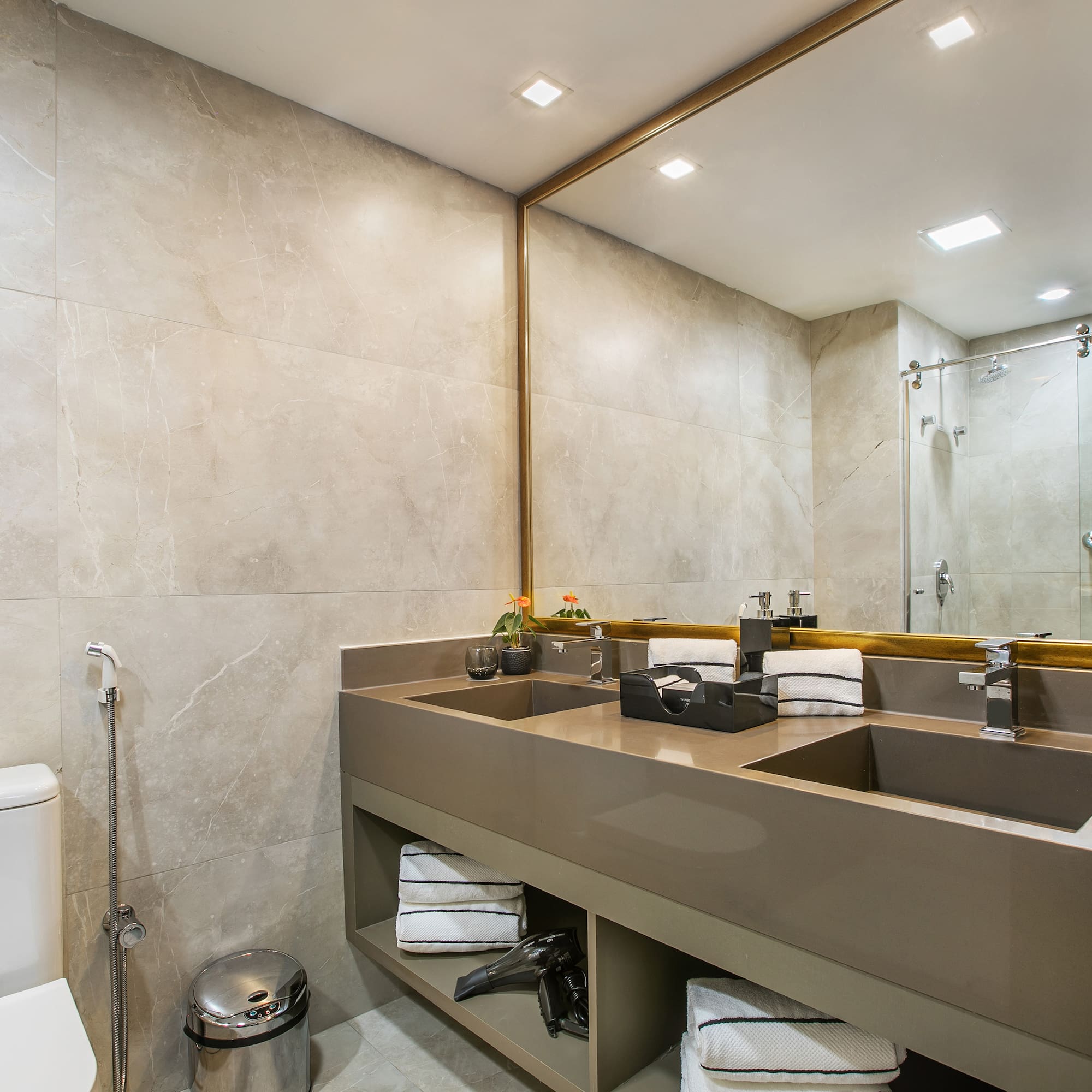a bathroom with a large mirror and sinks