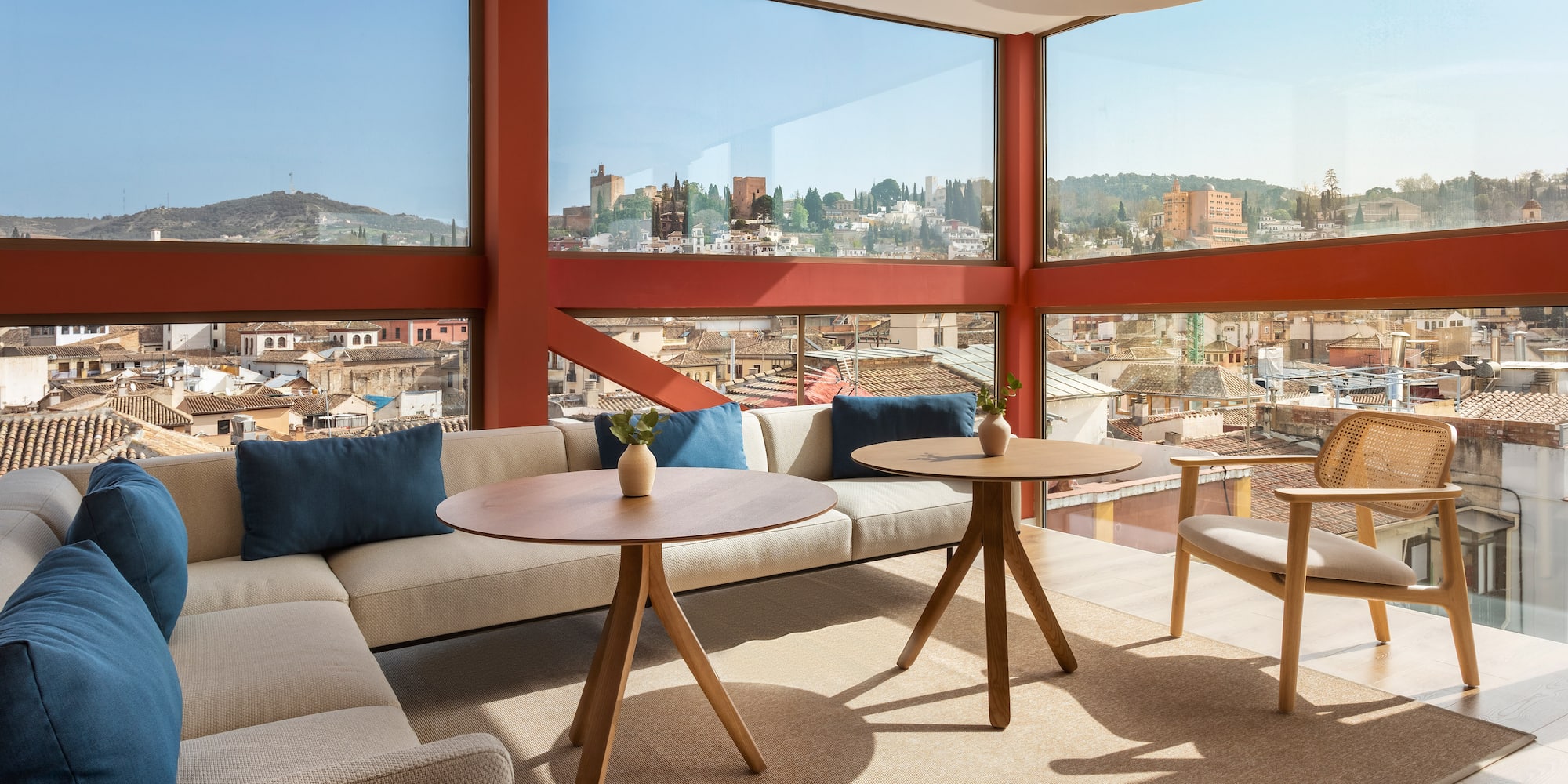 a room with a large window and a couch and chairs