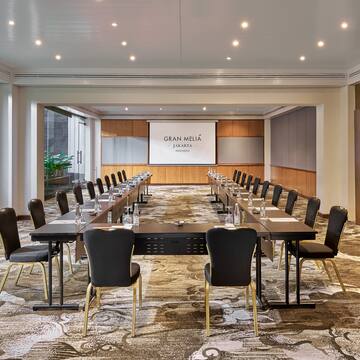 a room with a large table and chairs