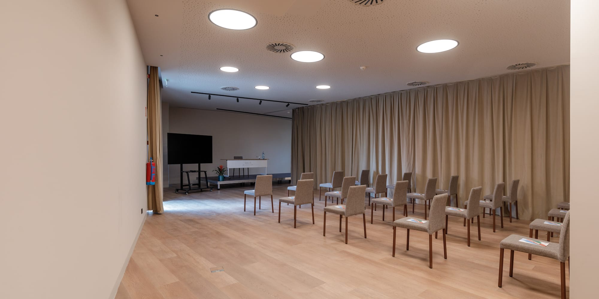 a room with chairs and a tv