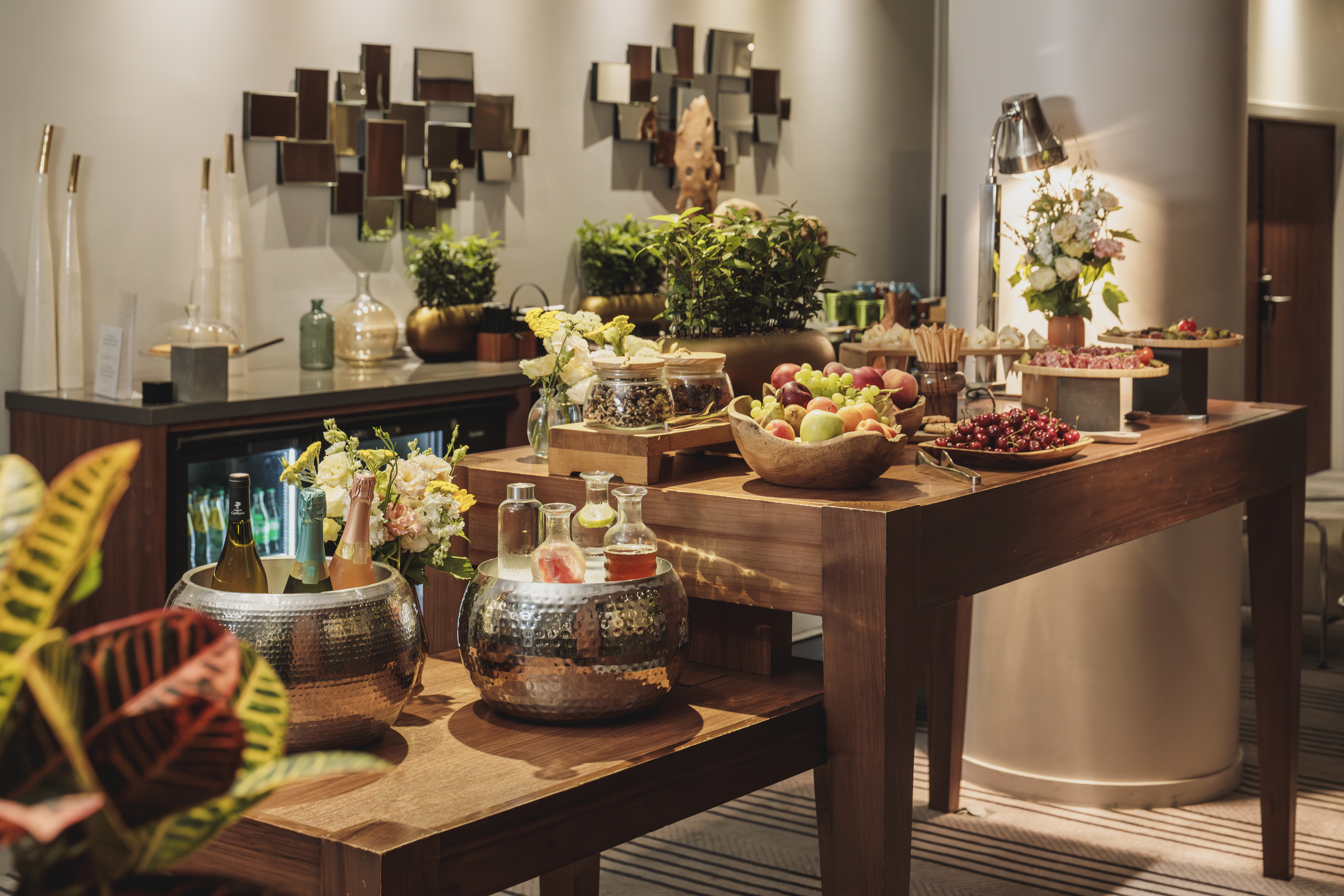 Elegant hotel reception buffet with fresh fruit, champagne, and appetizers.