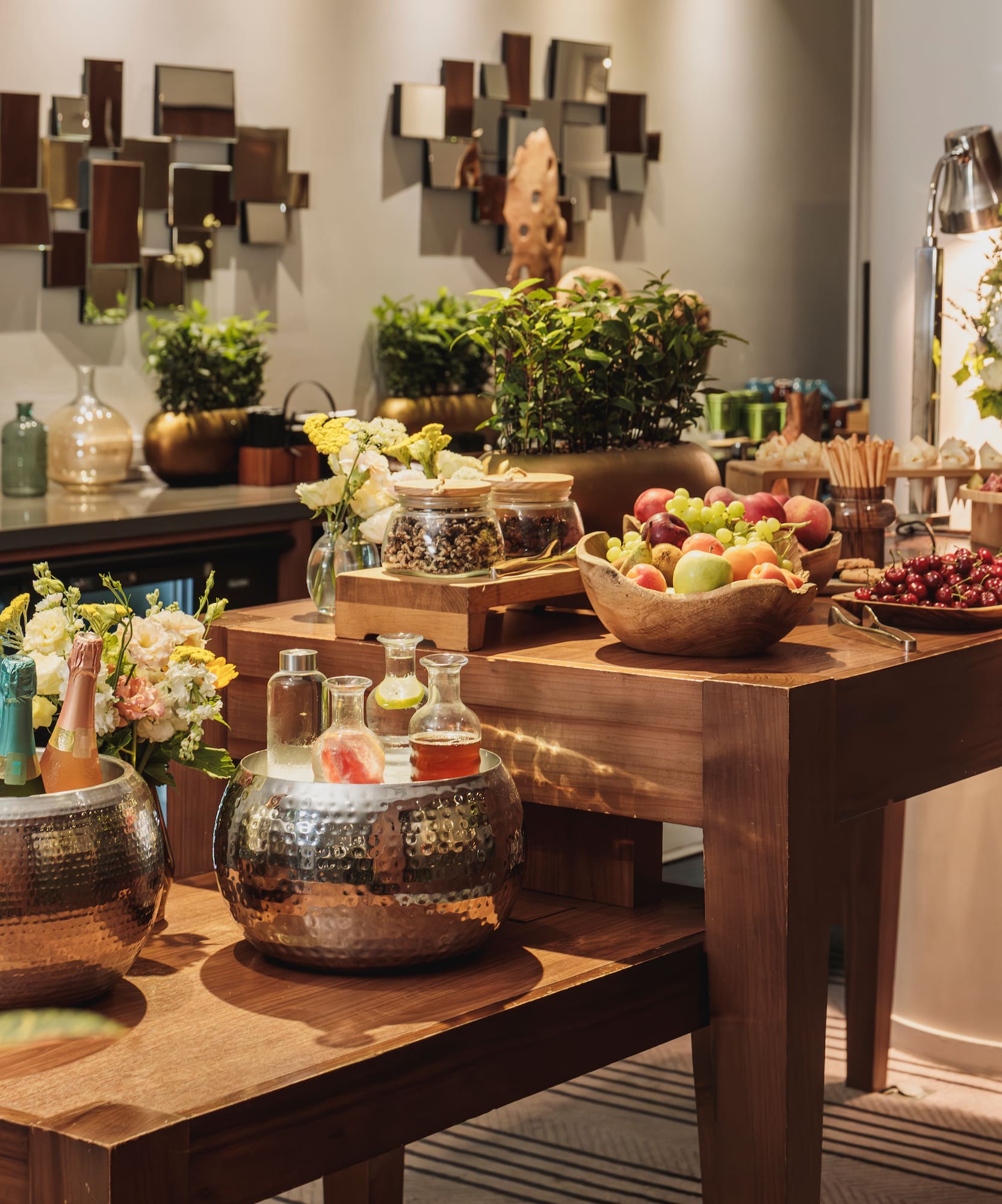 Elegant hotel reception buffet with fresh fruit, champagne, and appetizers.