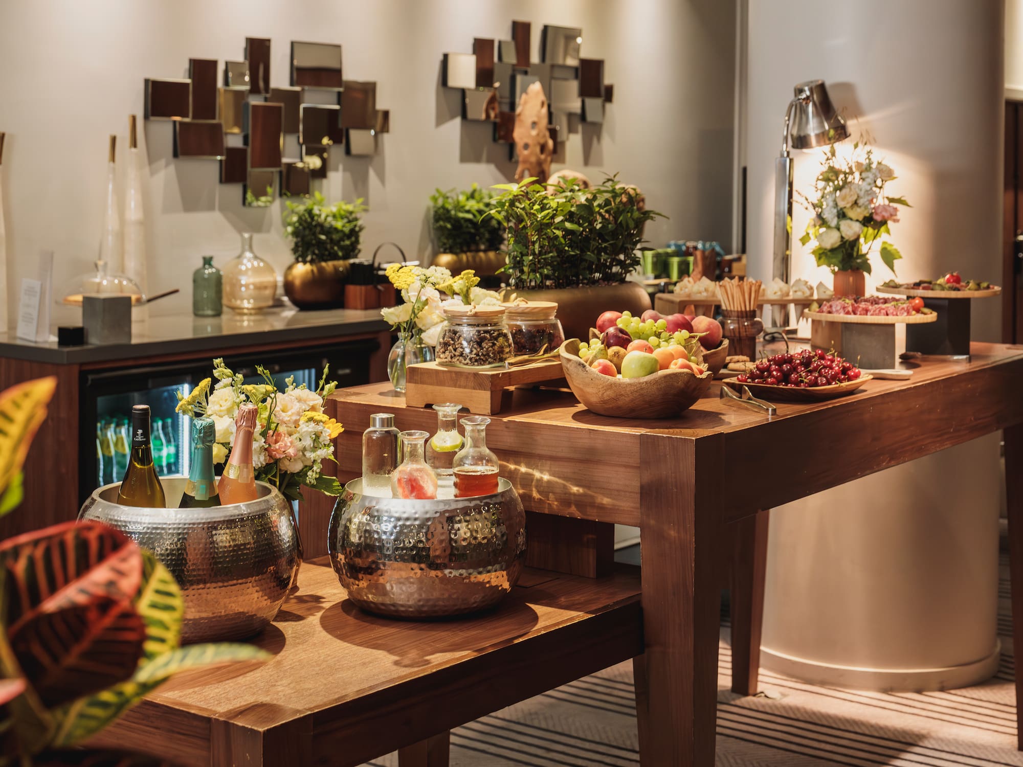 Elegant hotel reception buffet with fresh fruit, champagne, and appetizers.