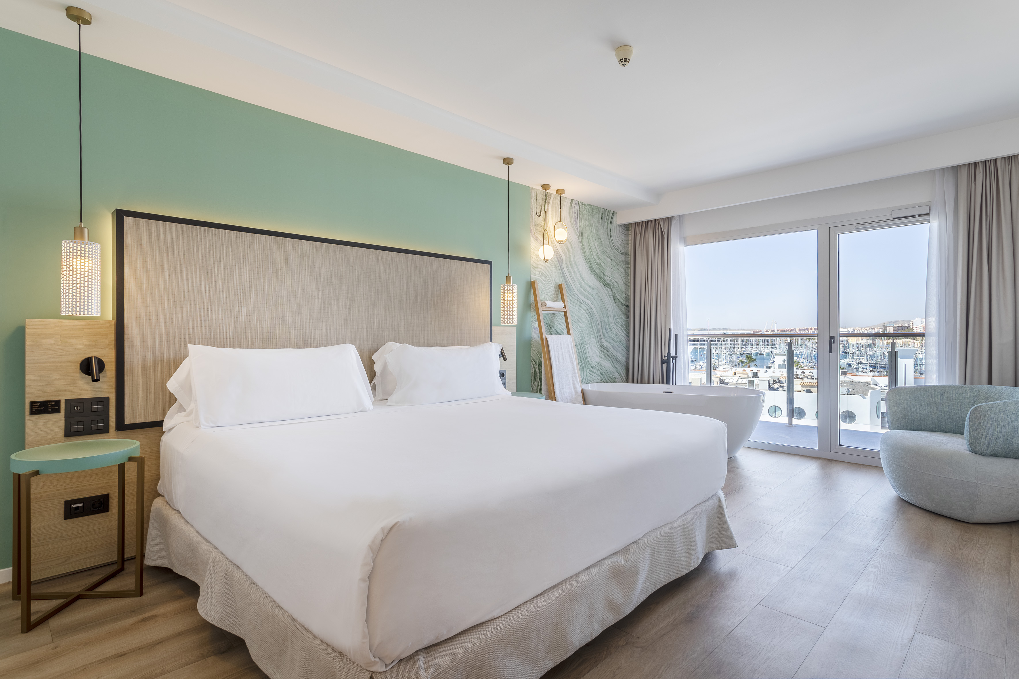 a bedroom with a large bed and a tub