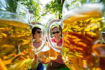 a group of people holding glasses of beer
