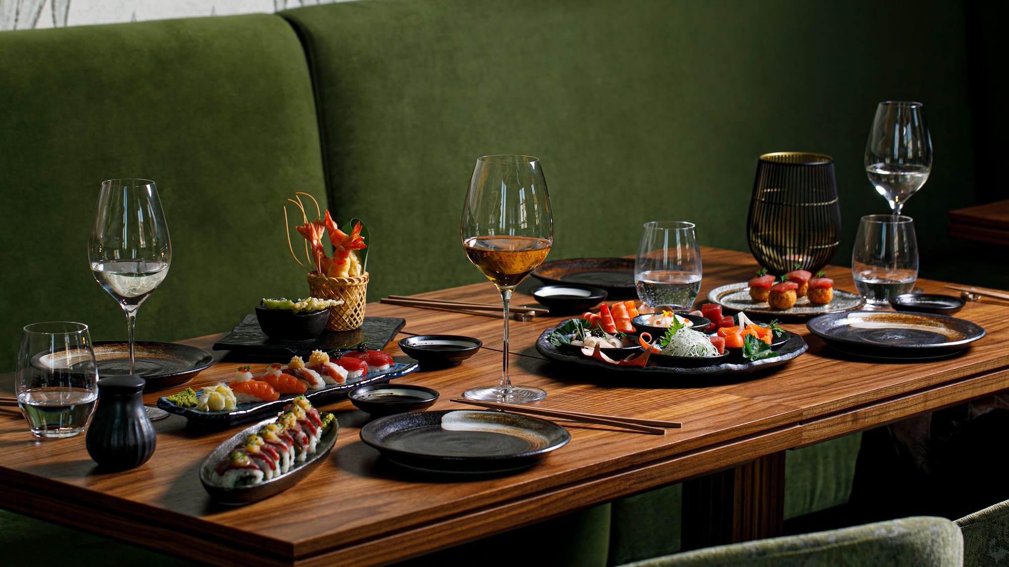 a table with plates of food and wine glasses