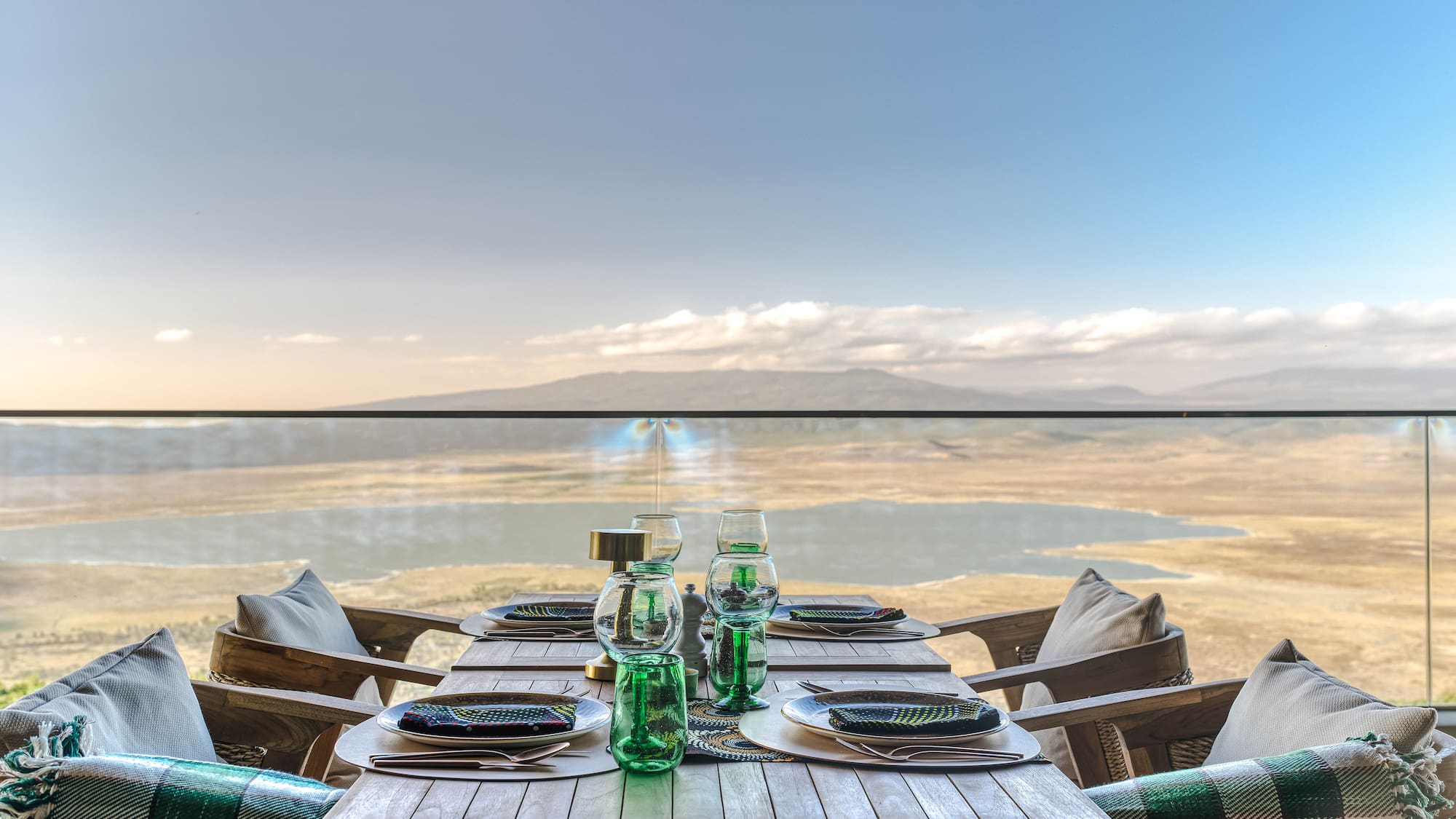 a table set for a dinner with a view of the ocean