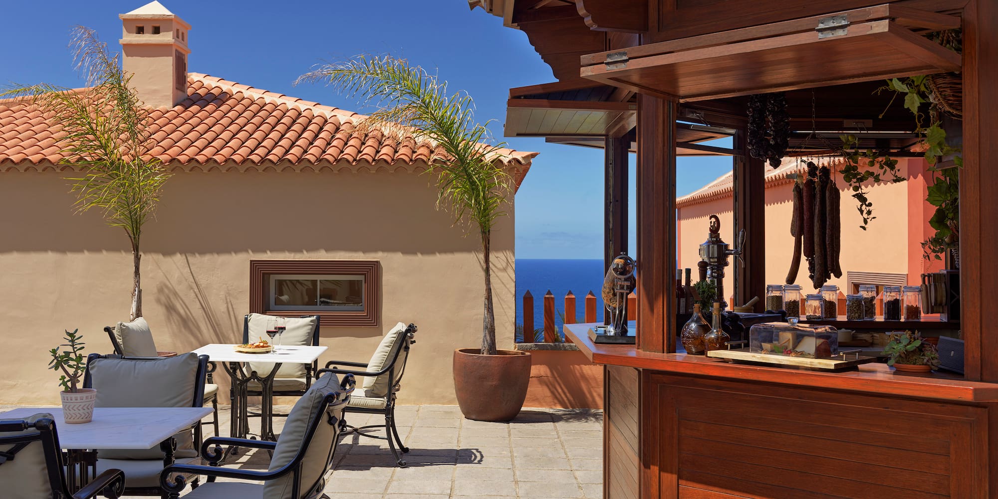 a patio with a bar and chairs