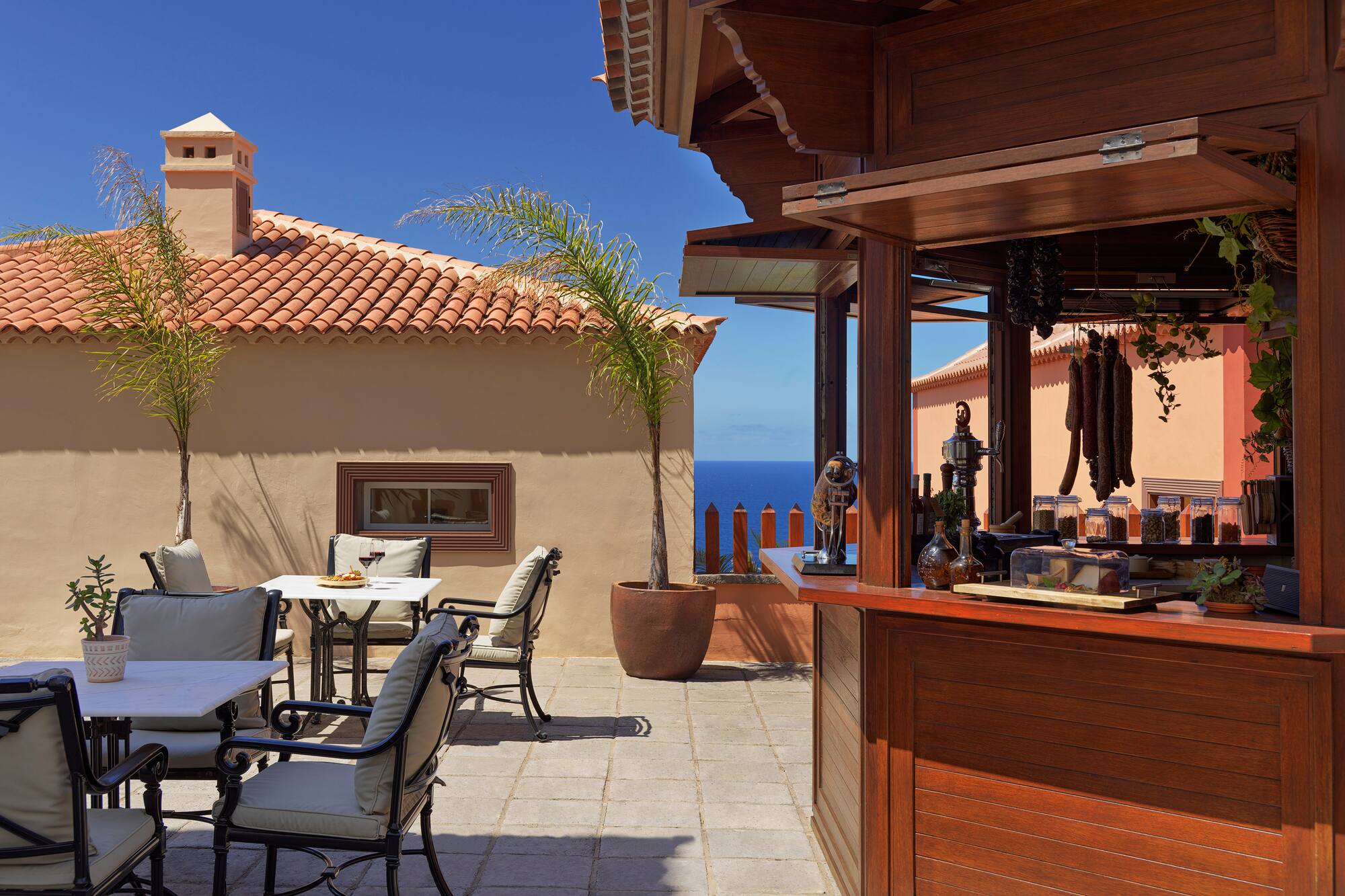 Outdoor Mediterranean bar and dining terrace with ocean view.