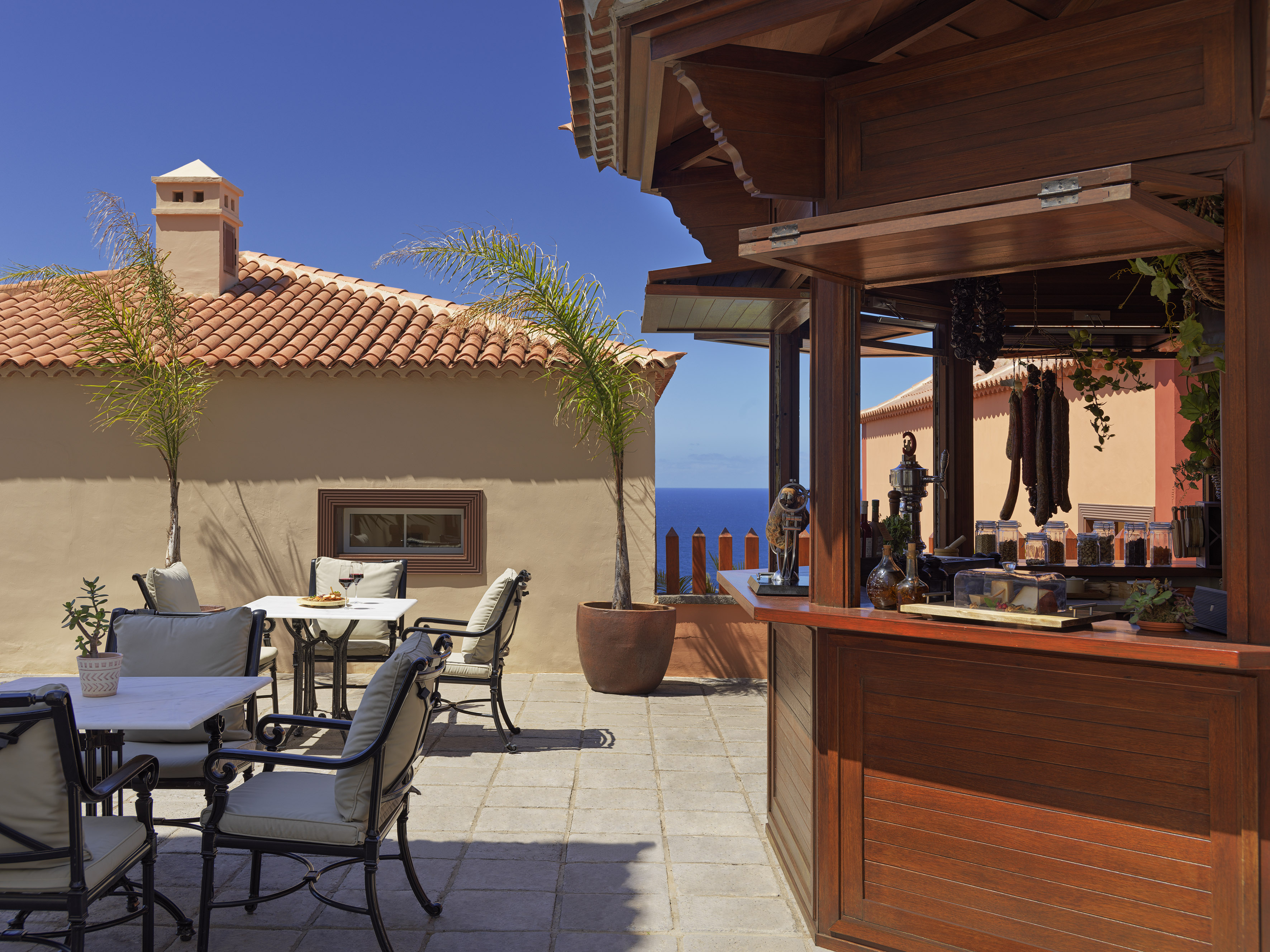 Outdoor Mediterranean bar and dining terrace with ocean view.
