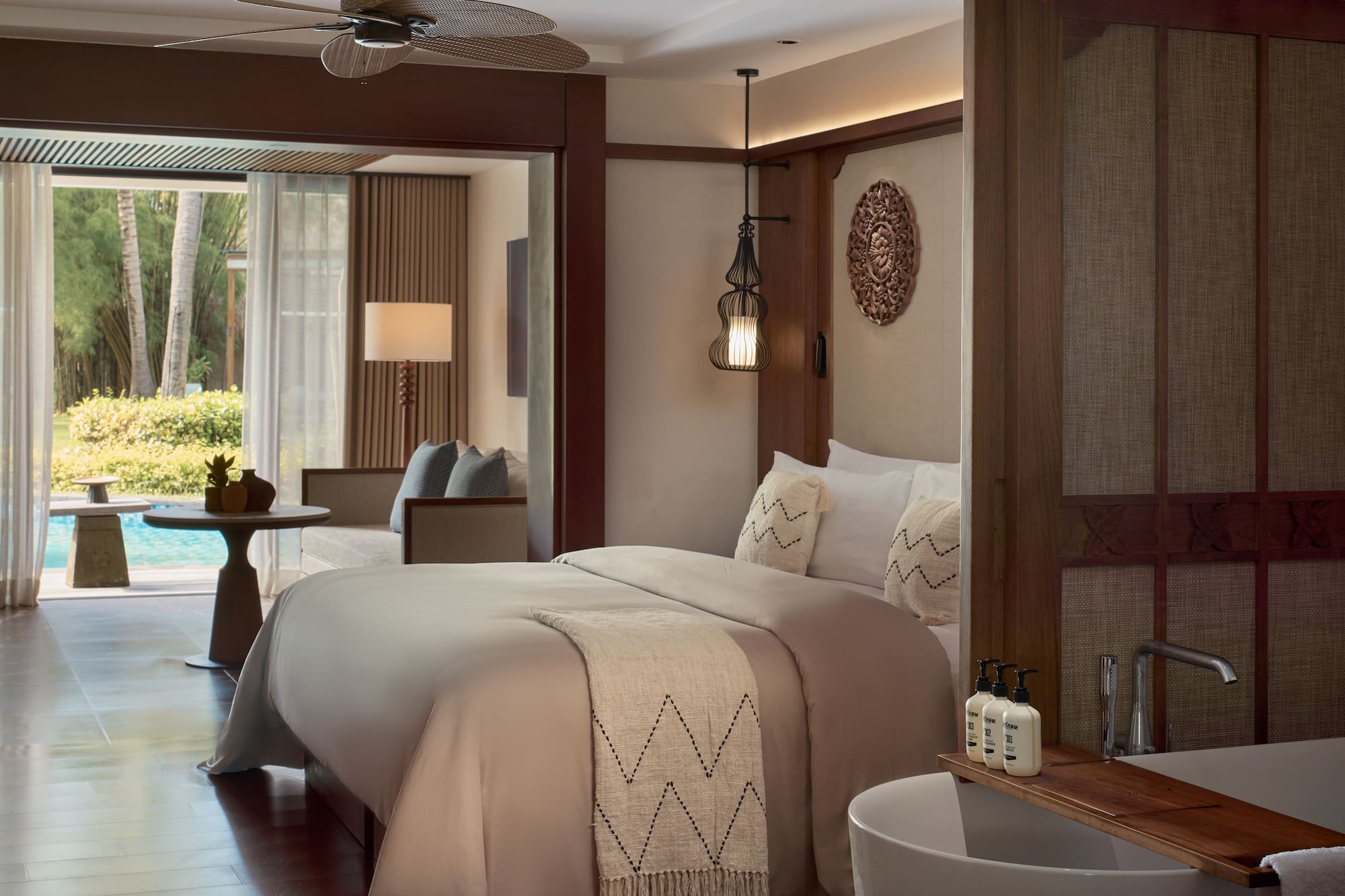 a room with a bed and a ceiling fan